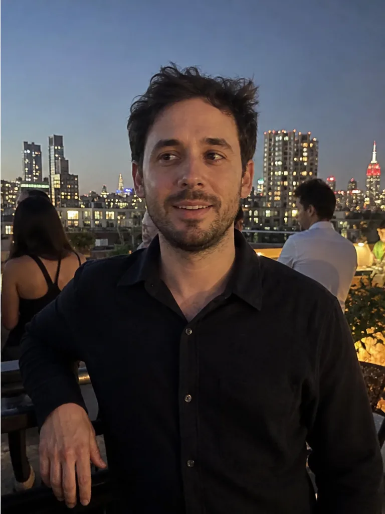 After Profile Maxed: confident smile, rooftop skyline at dusk
